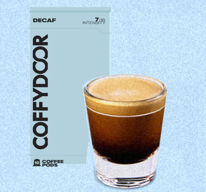 Coffydoor Decaf pod box beside a glass of decaf coffee