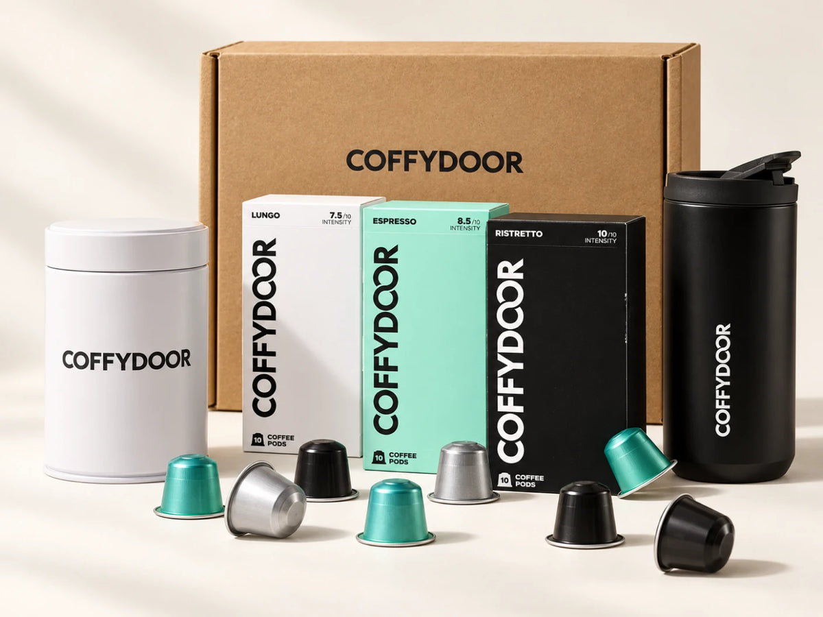 Coffydoor starter kit: a shipping box, four pod cartons, a storage tin, a travel mug and loose pods